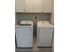 Well-organized laundry room with white appliances and storage cabinets at 7763 Park Gate Dr, North Charleston, SC 29418