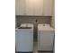 Well-organized laundry room with white appliances and storage cabinets at 7763 Park Gate Dr, North Charleston, SC 29418