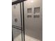 Contemporary shower featuring gray tiling with built-in shelving and a glass door at 7763 Park Gate Dr, North Charleston, SC 29418