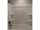 A clean white shower featuring shelves and gold fixtures at 7763 Park Gate Dr, North Charleston, SC 29418