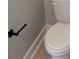 Close-up of a modern toilet with black towel holder and neutral wall color at 7763 Park Gate Dr, North Charleston, SC 29418