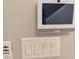 Wall-mounted control panel featuring multiple light switches and a smart home system at 7763 Park Gate Dr, North Charleston, SC 29418