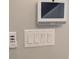 Wall-mounted control panel featuring multiple light switches and a smart home system at 7763 Park Gate Dr, North Charleston, SC 29418