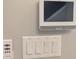 Wall-mounted control panel featuring multiple light switches and a smart home system at 7763 Park Gate Dr, North Charleston, SC 29418
