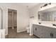 Bathroom featuring a double sink vanity, mirror, walk-in shower and a connected walk-in closet at 8044 Old London Rd, North Charleston, SC 29406