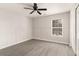 An empty bedroom with gray hardwood flooring, a ceiling fan, board and batten, and a window at 8044 Old London Rd, North Charleston, SC 29406