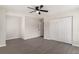 A view of an empty bedroom with closet and doorway, gray hardwood flooring, and a ceiling fan at 8044 Old London Rd, North Charleston, SC 29406