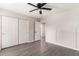 A view of an empty bedroom with closet and doorway, gray hardwood flooring, and board and batten at 8044 Old London Rd, North Charleston, SC 29406