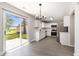 Bright kitchen with white cabinetry and stainless steel appliances opening to the backyard at 8044 Old London Rd, North Charleston, SC 29406