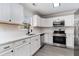 Modern kitchen featuring white cabinets, stainless steel appliances, and a subway tile backsplash at 8044 Old London Rd, North Charleston, SC 29406