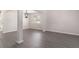 Bright living room with gray floors, white walls, open stairs and a decorative chandelier at 8044 Old London Rd, North Charleston, SC 29406