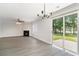 Spacious living room with fireplace, fan, large windows, and sliding doors to the patio with an outdoor view at 8044 Old London Rd, North Charleston, SC 29406