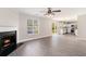 Bright living room with fireplace, ceiling fan, and sliding doors to the outside and an open view into the kitchen at 8044 Old London Rd, North Charleston, SC 29406