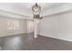 Bright living room with gray floors, white walls, open stairs and a decorative chandelier at 8044 Old London Rd, North Charleston, SC 29406