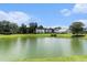 A serene community pond surrounded by lush trees and well-maintained homes at 8044 Old London Rd, North Charleston, SC 29406