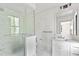 Modern bathroom featuring a glass-enclosed shower, sleek fixtures, and marble tile at 8187 Jack Island Dr, Johns Island, SC 29455