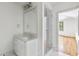 Modern bathroom with a glass shower, a marble vanity, and a large mirror at 8187 Jack Island Dr, Johns Island, SC 29455