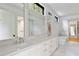 Elegant bathroom featuring double sinks, marble countertops, a soaking tub, and a separate shower at 8187 Jack Island Dr, Johns Island, SC 29455