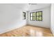 Bright bedroom featuring light wood floors and large windows with wooded views at 8187 Jack Island Dr, Johns Island, SC 29455