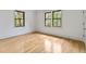 Bright bedroom featuring light wood floors and large windows with wooded views at 8187 Jack Island Dr, Johns Island, SC 29455