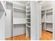 Spacious walk-in closet with custom shelving and hardwood floors at 8187 Jack Island Dr, Johns Island, SC 29455