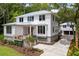 Beautiful two-story home with a metal roof, a garage, and mature landscaping at 8187 Jack Island Dr, Johns Island, SC 29455