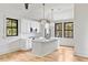 Bright kitchen with an island, white cabinets, and stainless steel appliances at 8187 Jack Island Dr, Johns Island, SC 29455