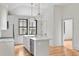 Cozy kitchen featuring white cabinets, an island, and modern pendant lighting at 8187 Jack Island Dr, Johns Island, SC 29455