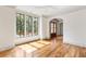 Bright living room with hardwood floors, a ceiling fan, and large windows overlooking the backyard at 8187 Jack Island Dr, Johns Island, SC 29455