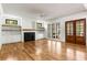 Spacious living room with a fireplace, built-in shelves, and hardwood floors at 8187 Jack Island Dr, Johns Island, SC 29455