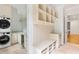 Mudroom features a washer and dryer, storage, coat hooks, and bench at 8187 Jack Island Dr, Johns Island, SC 29455