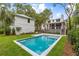 Backyard view of a modern pool and patio with the main house in the background at 8187 Jack Island Dr, Johns Island, SC 29455