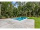 Backyard features a modern pool and lush landscaping, creating a serene oasis at 8187 Jack Island Dr, Johns Island, SC 29455