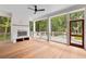 Large screened porch with a fireplace, ceiling fan, and views of the pool and backyard at 8187 Jack Island Dr, Johns Island, SC 29455