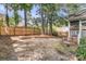 Spacious backyard featuring a wooden fence, mature trees, and access to screened porch at 8618 Woodland Walk, North Charleston, SC 29420