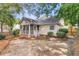View of backyard with brick and screen porch, and lots of green trees at 8618 Woodland Walk, North Charleston, SC 29420