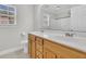 Bright bathroom featuring double sinks, neutral paint, large window, and walk in shower at 8618 Woodland Walk, North Charleston, SC 29420