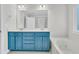 This updated bathroom features a shower, soaking tub, and a blue double sink vanity at 8618 Woodland Walk, North Charleston, SC 29420
