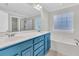 This updated bathroom features a shower, soaking tub, and a blue double sink vanity at 8618 Woodland Walk, North Charleston, SC 29420