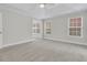 Spacious bedroom with neutral carpet, ceiling fan, and natural light from multiple windows at 8618 Woodland Walk, North Charleston, SC 29420