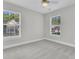A bedroom featuring neutral carpet, trim and paint, and windows with natural light at 8618 Woodland Walk, North Charleston, SC 29420