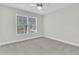 Neutral bedroom with light colored carpet, base trim and a window providing natural light at 8618 Woodland Walk, North Charleston, SC 29420