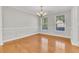 Elegant dining room featuring hardwood floors, a chandelier, and large windows at 8618 Woodland Walk, North Charleston, SC 29420