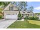 Charming home featuring a two-car garage, landscaped front yard, and a welcoming porch at 8618 Woodland Walk, North Charleston, SC 29420