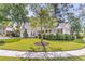 Well-maintained home with mature trees, lush lawn, and classic architecture at 8618 Woodland Walk, North Charleston, SC 29420