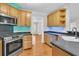 The kitchen showcases stainless steel appliances, wooden cabinets, and stylish countertops at 8618 Woodland Walk, North Charleston, SC 29420