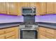 The kitchen showcases stainless steel appliances and light wood cabinets at 8618 Woodland Walk, North Charleston, SC 29420