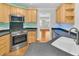 The kitchen showcases stainless steel appliances and light wood cabinets at 8618 Woodland Walk, North Charleston, SC 29420