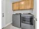 The laundry room has side-by-side gray front-loading washer and dryer at 8618 Woodland Walk, North Charleston, SC 29420