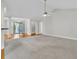 Spacious open-concept living room with neutral carpet and trim, and a light ceiling fan at 8618 Woodland Walk, North Charleston, SC 29420